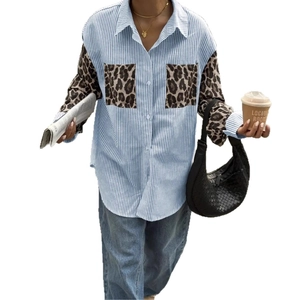 Detail of loose fit long sleeve shirt with blue stripes and leopard print pocket