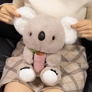 Lifelike gray plush koala toy with pink accessory held by a model for soft tactile display