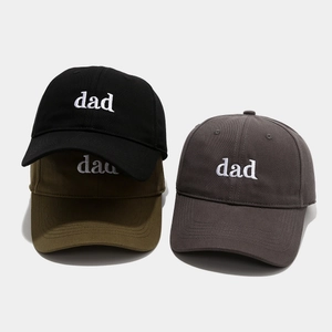 Detail view of cotton twill baseball caps in black, green and grey with dad embroidery