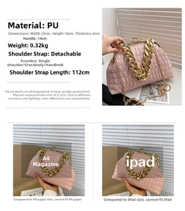Detail of pink pleated shell bag featuring a thick gold chain and removable strap
