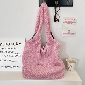 Detail of pink leopard print plush tote bag with black and white checkered lining