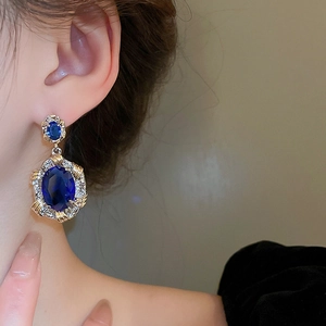Vintage French style oval blue zircon earrings with gold braided metal border on model
