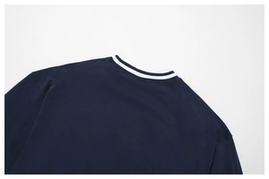 Close-up of contrast stripe ribbed neckline and soft knit texture on navy sweatshirt
