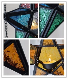 Detailed macro view of colorful patterned glass and vintage metal star candle lanterns
