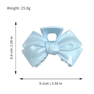 Mint blue bow hair claw clip with star detail, 9.1cm wide, weight 25.9g product dimensions