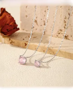 Detailed comparison of large and small pink gemstone pendants on silver chains