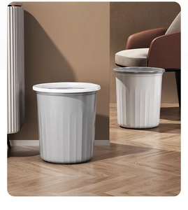 Modern grey and white striped plastic waste bins in a minimalist living room setting