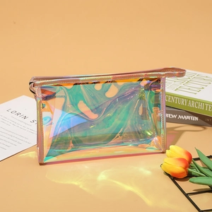 Multifunctional holographic laser cosmetic bag with pink zipper and handle on peach background