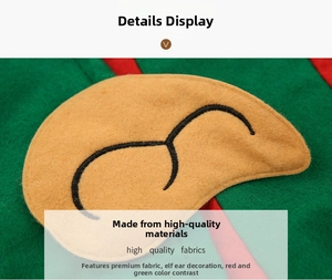 Close-up of green non-woven Christmas hat with red trim and brown elf ear details