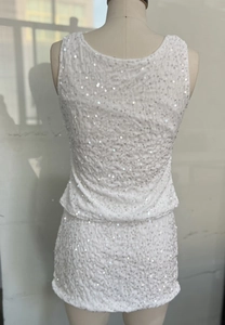 Detail of white sequin crop top and mini skirt set back view on a mannequin