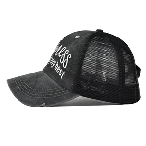 Detail of distressed ponytail baseball cap with mess my best embroidery and mesh back