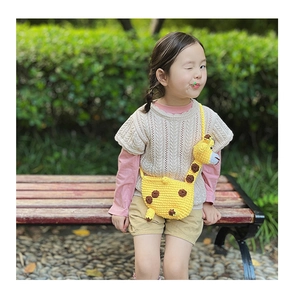 Close-up of a handcrafted crochet giraffe crossbody bag with 3D cute animal details