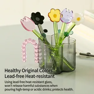 Colorful floral borosilicate glass stirrers in a stylish grey textured glass cup