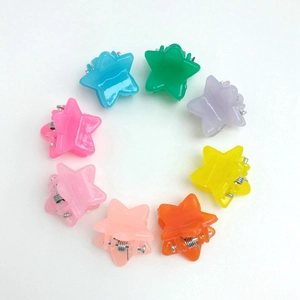 Mini macaron star hair claws in eight assorted translucent colors arranged in a circle