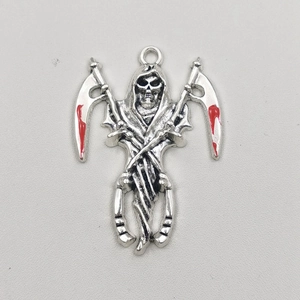 Detail of silver grim reaper skull pendant with red scythe blades in gothic style