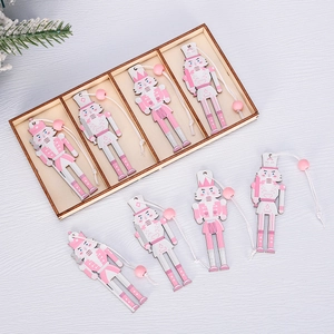 Detailed set of 8 pink and silver wooden nutcracker ornaments with storage box