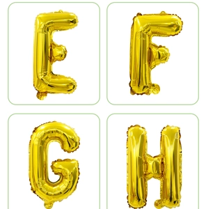 Detail of gold foil alphabet balloons E, F, G, H with shiny metallic finish for party decor