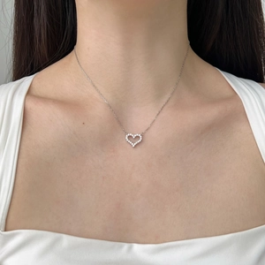 Elegant S925 sterling silver heart pendant necklace with zircon stones on female model
