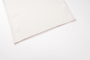 Detailed view of the double-stitched hem on a soft pink off-shoulder bodycon dress