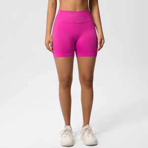Close-up of high-waisted seamless fitness shorts in rose red with body-shaping waistband