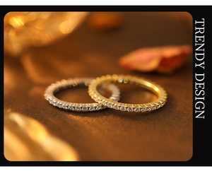 Macro shot of silver and gold full eternity rings with sparkling CZ stones inlay