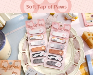 Detailed view of cat paw shaped index stickers in a decorative ceramic plate