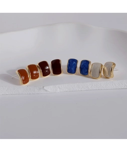 Detail showing four pairs of rectangular enamel stud earrings in assorted vintage colors