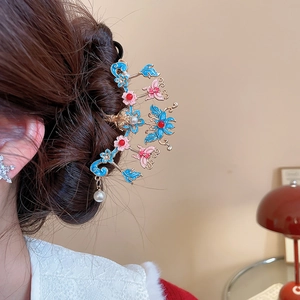 Détail d'une épingle à cheveux rétro avec fleurs en émail bleu et perle blanche pendante