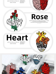 Detail of anatomical heart enamel pins with colorful roses and tulip flower designs