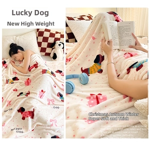 Detail of thick cream flannel blanket featuring cute red dogs and festive gift box patterns