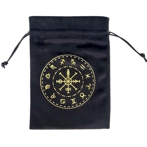 Detail of black velvet tarot pouch featuring golden zodiac signs and viking compass symbols