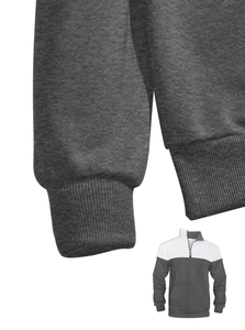 Close-up of ribbed cuffs and gray-white patchwork texture on waffle knit pullover