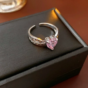 Macro shot of sparkling pink heart-shaped gemstone ring on black jewelry box