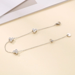Detailed close-up of a silver clover bracelet with sparkling pavé crystals and lobster clasp