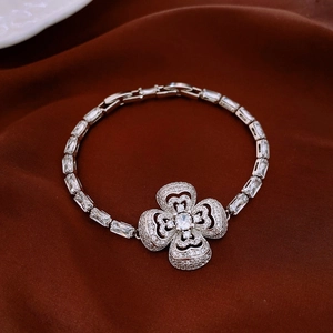 Macro shot of silver clover bracelet with cubic zirconia and rectangular cut stones