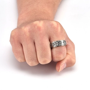 Macro shot of punk style spinner ring with skull and cross patterns on stainless steel