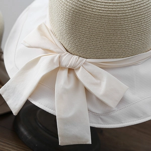 Summer woven straw sun hat with wide fabric brim and elegant cream bow tie for women