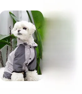 Detail view of hooded waterproof pet raincoat with snap buttons and color-blocking design