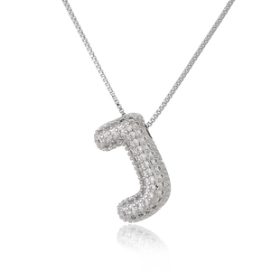 Macro shot of silver letter J pendant with micro-paved zircons and square box chain