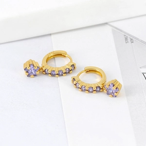 Close-up of gold S925 silver hoop earrings with purple star-shaped zircon pendants