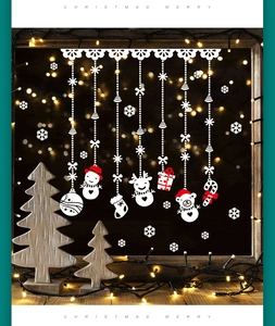 Detail of Christmas window stickers featuring snowman, reindeer and red ornaments