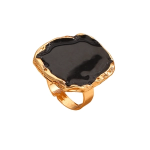 Close-up of vintage gold hammered ring with square black enamel inlay for women