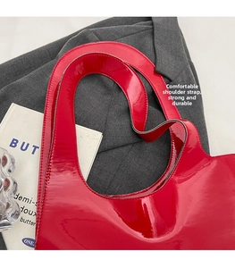 Detail of red patent leather shoulder strap attachment and reinforced stitching