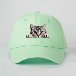 Close-up of mint green cotton baseball cap featuring a realistic peeping tabby cat print
