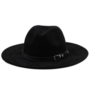 Detail of the black wide brim cowboy hat featuring a leather strap and silver buckle