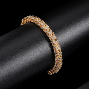 Lustrous 6mm gold-tone zirconia link bracelet wrapped on a textured black display pedestal