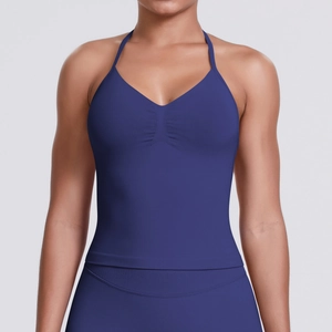 Detailed view of dark blue seamless sports bra with pleated front and halter straps
