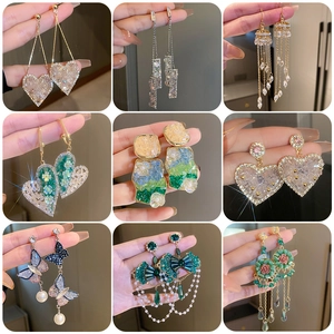 Collage of floral tassel earrings with faux pearls and crystals on silver needles
