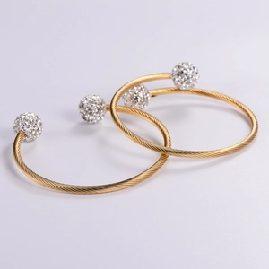 Adjustable gold twisted wire cable bracelet with sparkling crystal paved ball ends