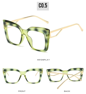 Detail view of cat eye glasses with green marble frame and golden hollow metal temples